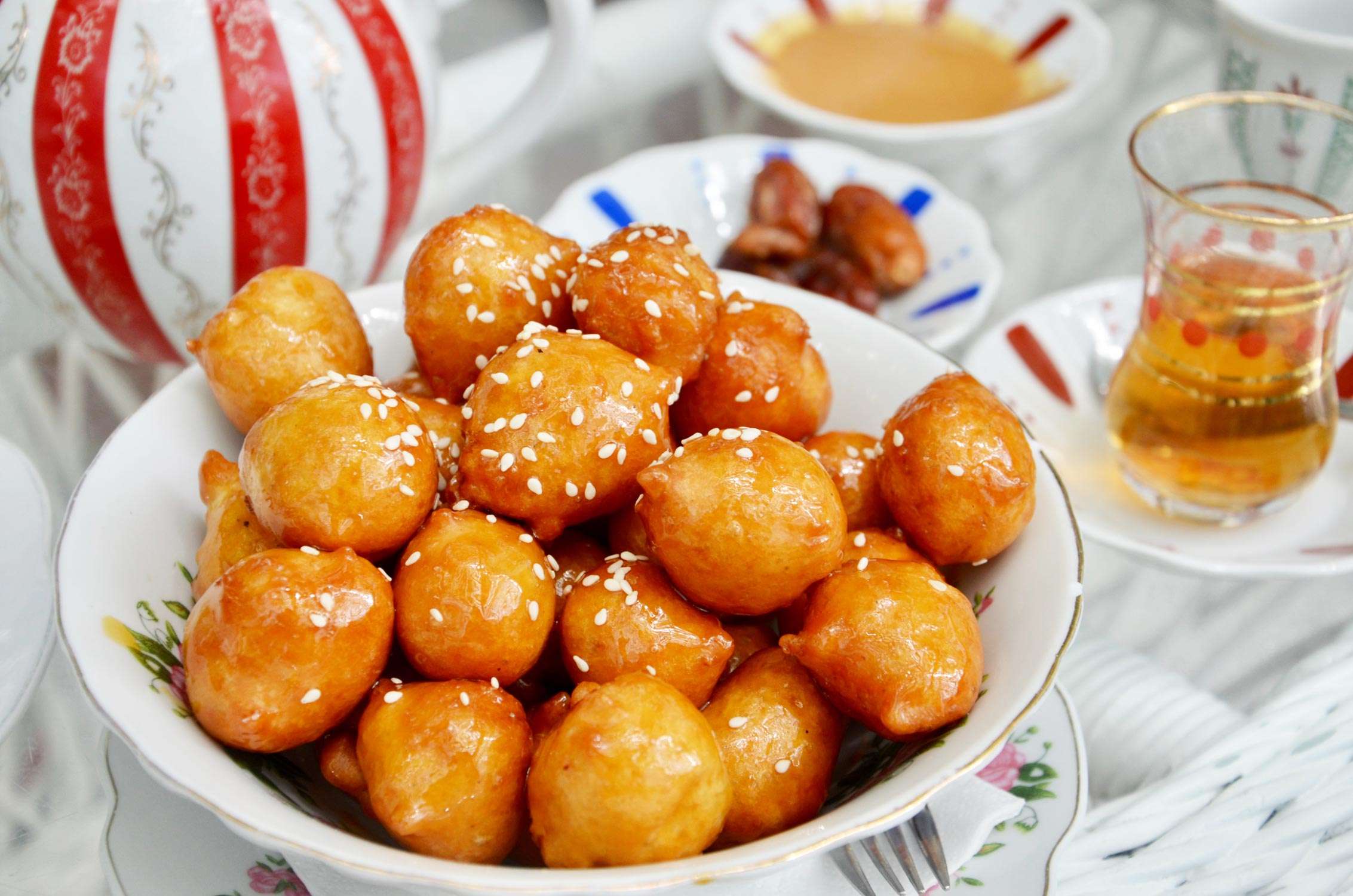 Traditional oriental dessert speciality Legematt, fried dough balls in a porcelain bowl