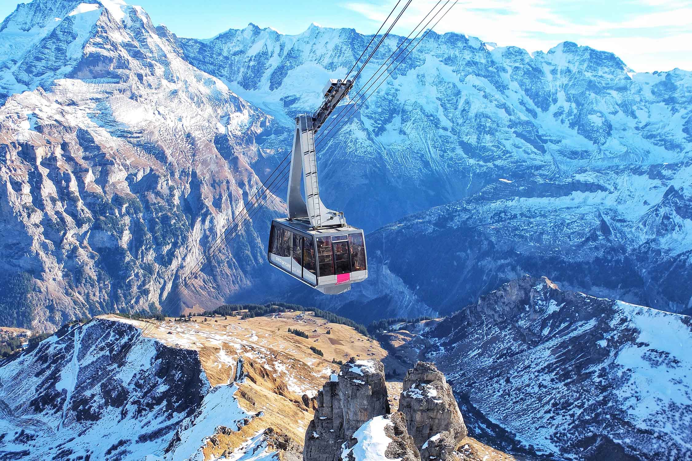 Bird's eye view of ski lift over Alps during winter