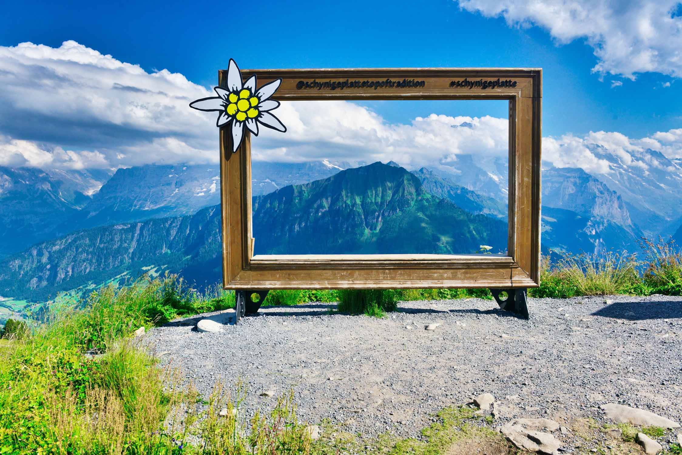 A sign with Alps in the background photo