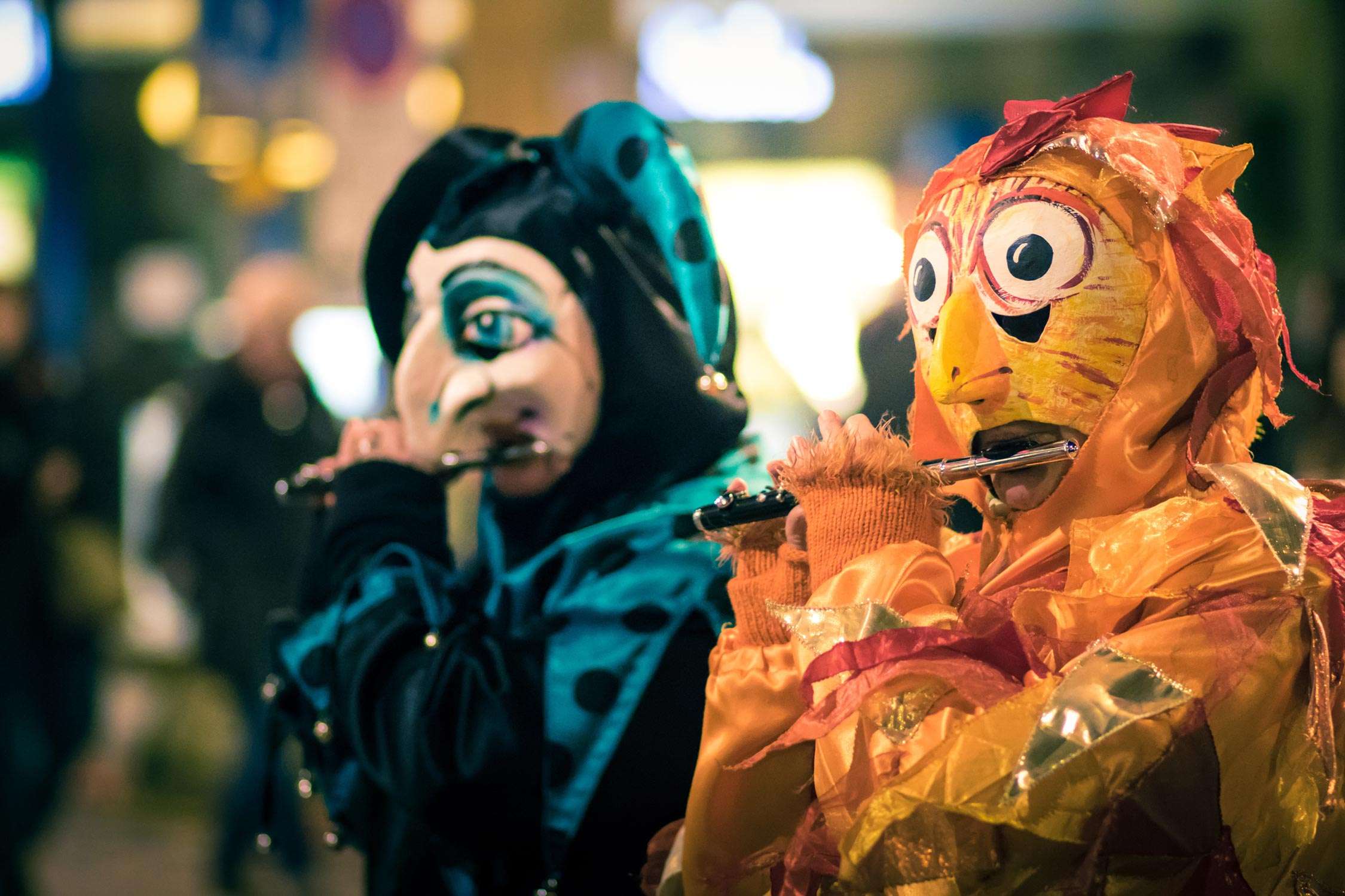 People wear masks while playing a wind instrument during the Fasnacht