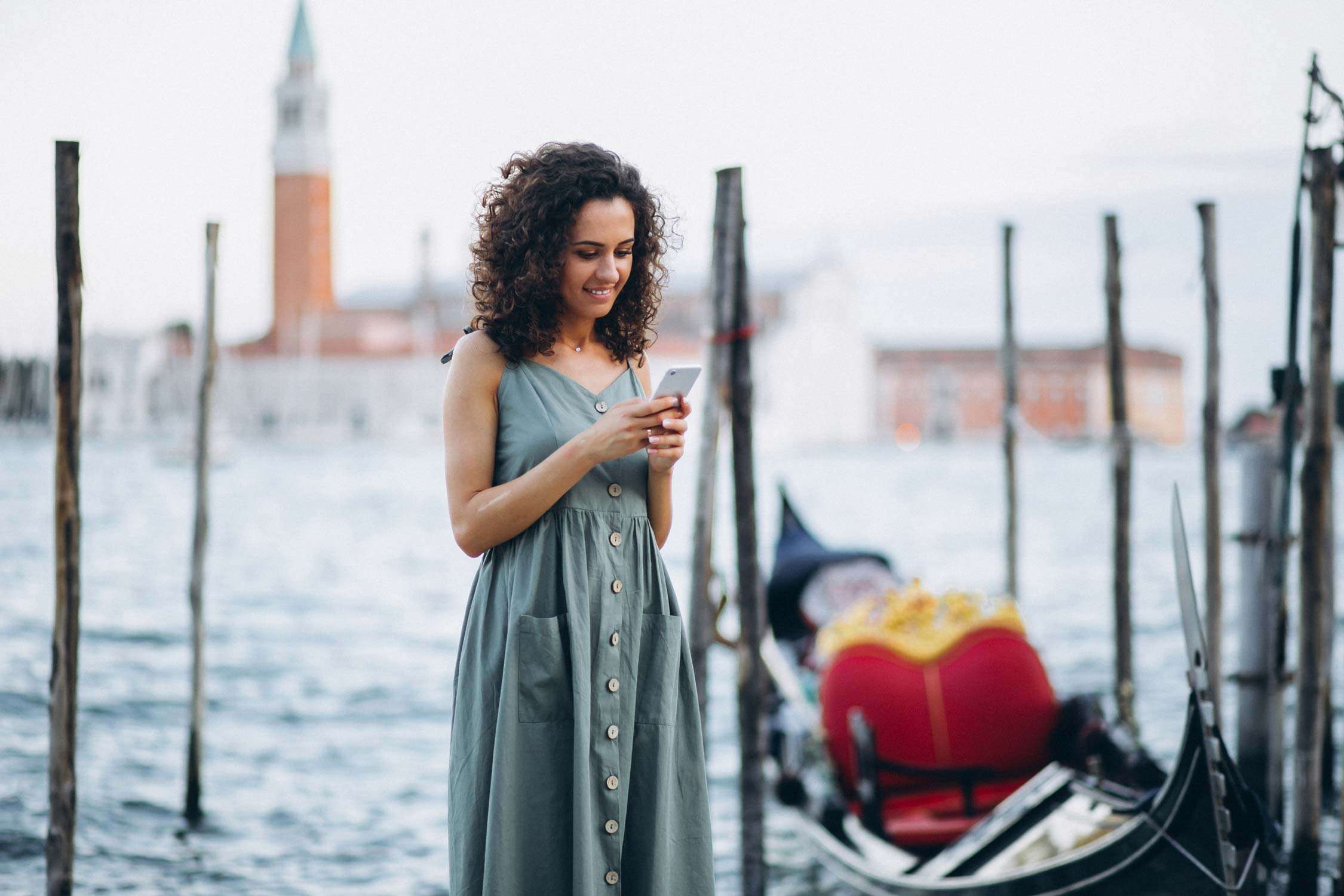 Woman with phone on vacation in venice