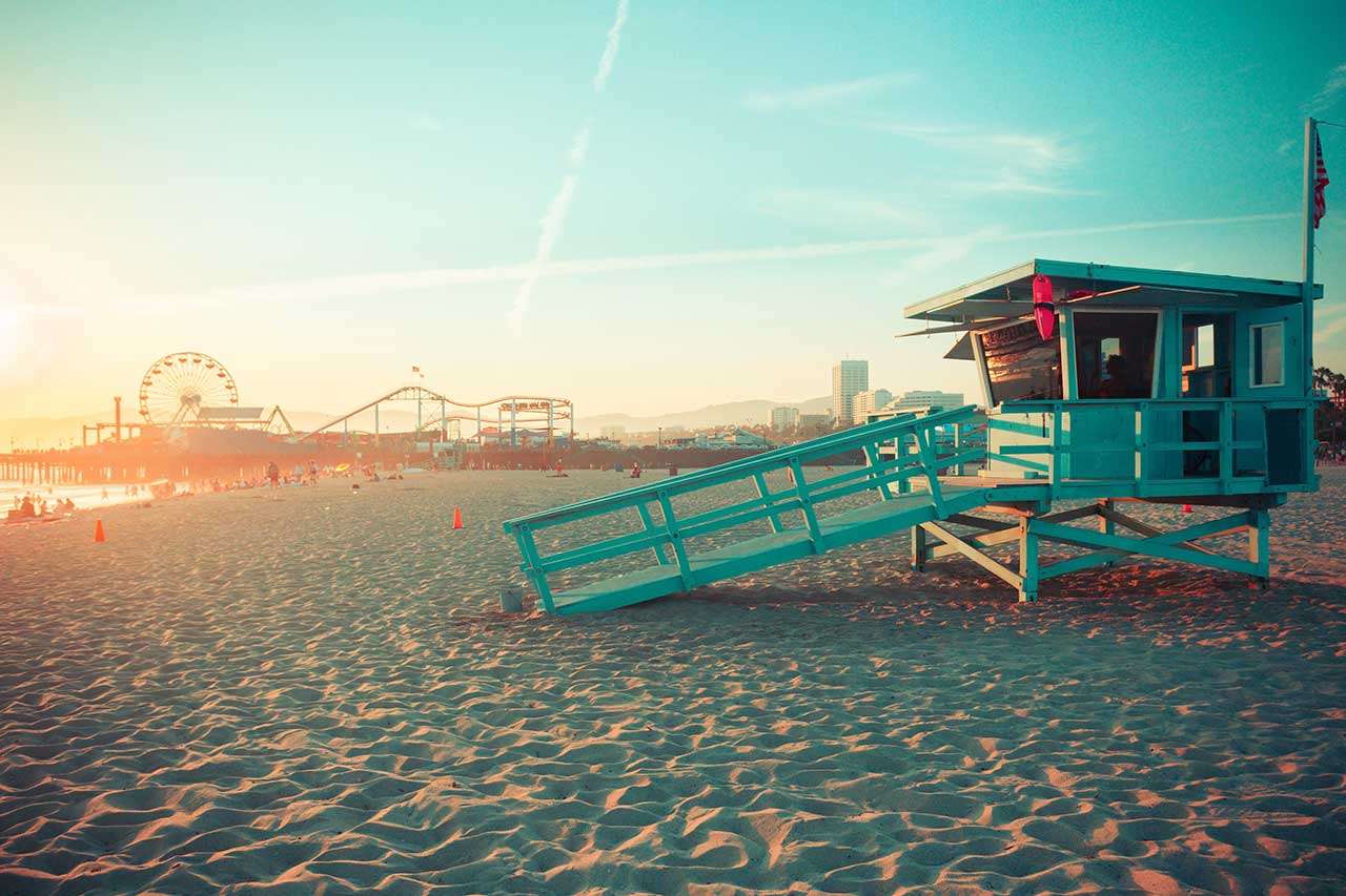 Santa Monica rescue cabin against famous amusement park in sunset