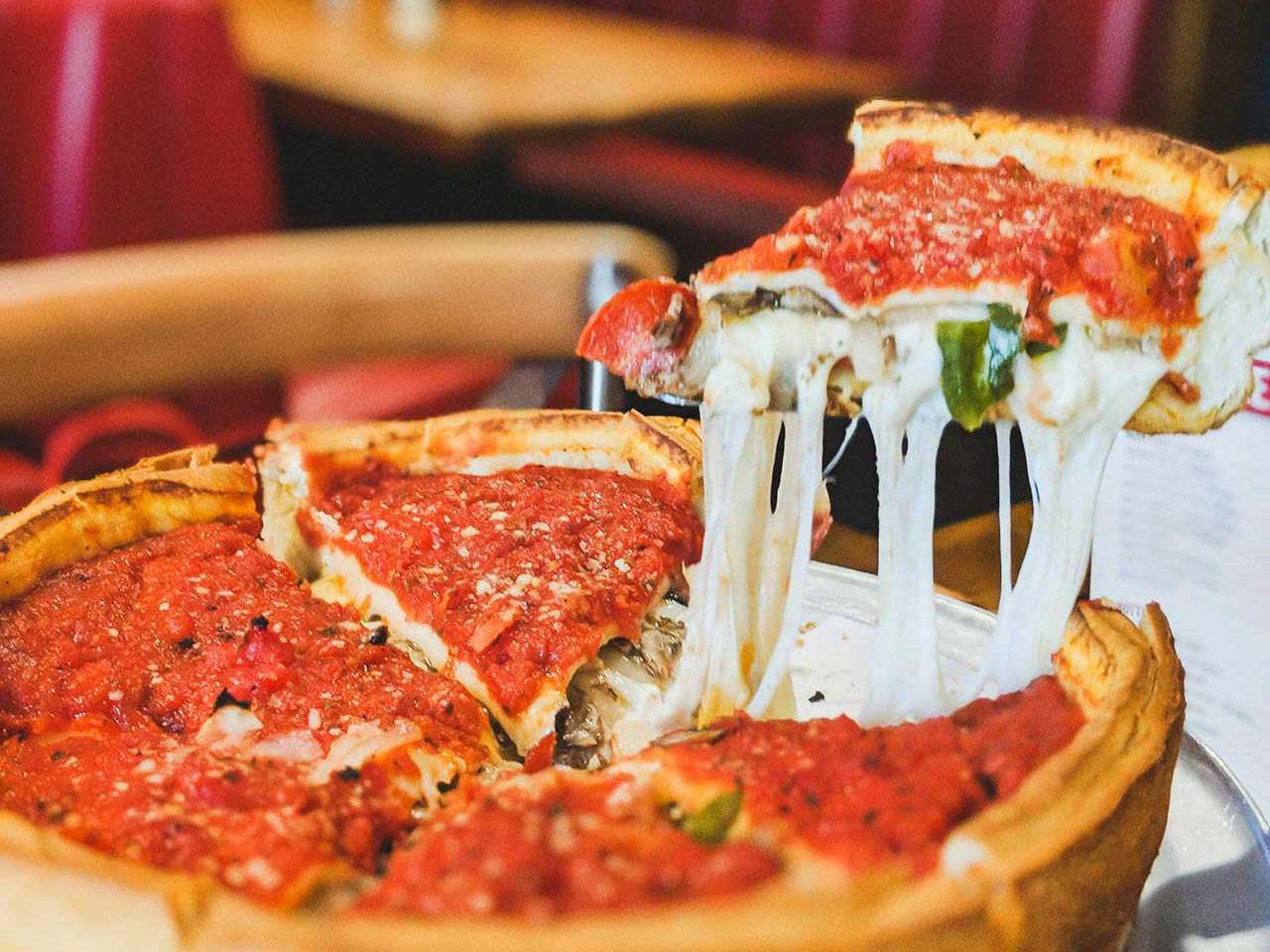 Deep-dish pizza with green leaf toppings in Chicago