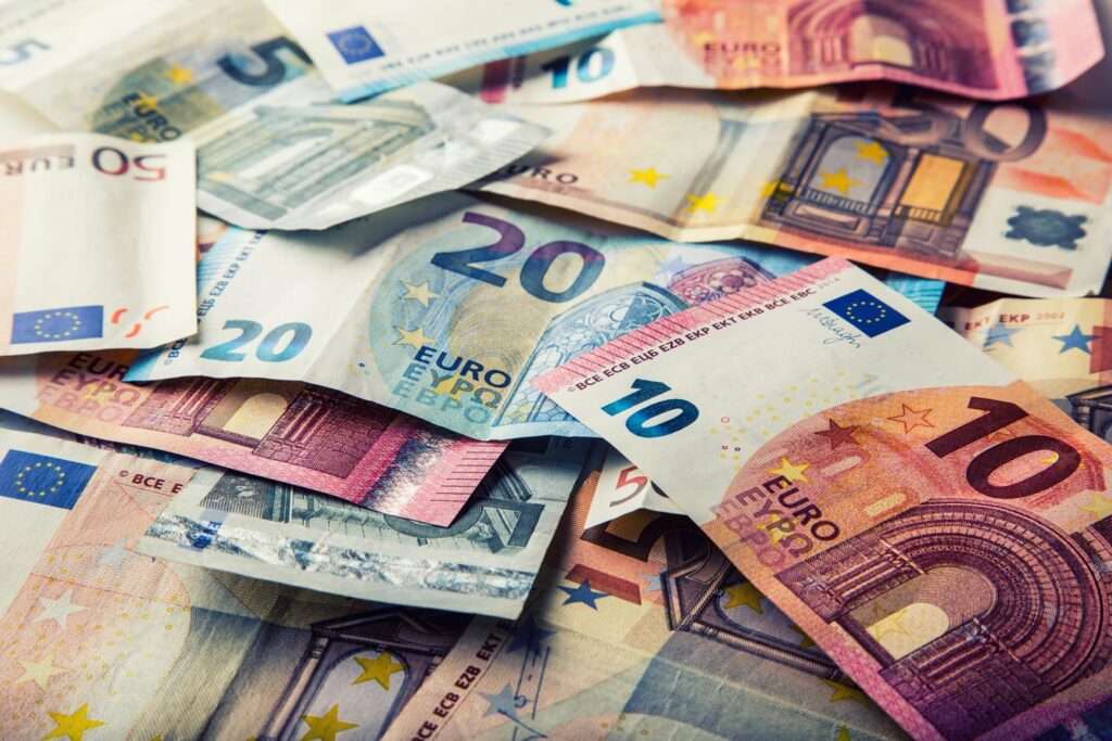 Euro banknotes scattered in various denominations.