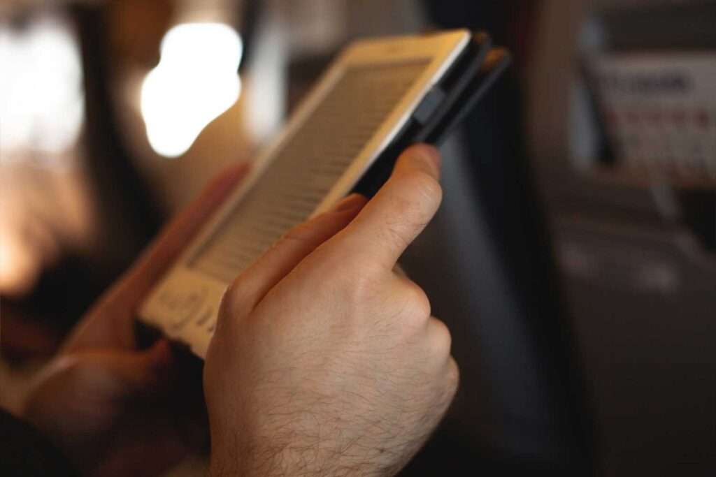 Man reading an e-book on an airplane