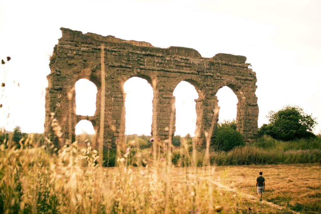 Roman aqueduct at sunset in the Aqueduct Park in the south of Rome