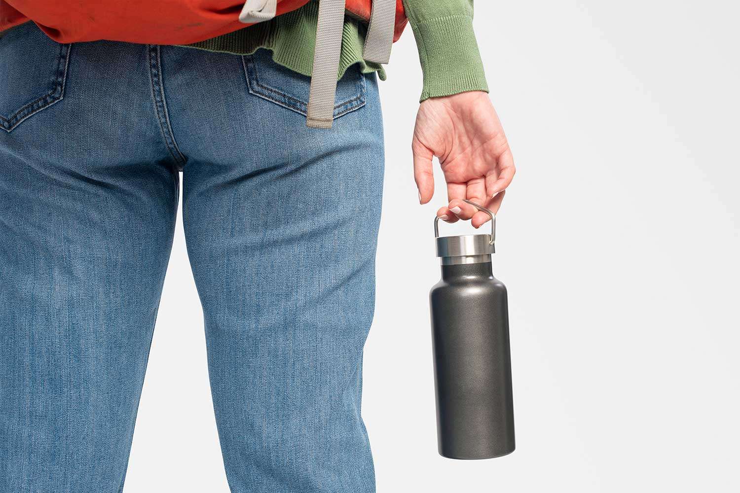 Hand of woman holding stainless steel water bottle