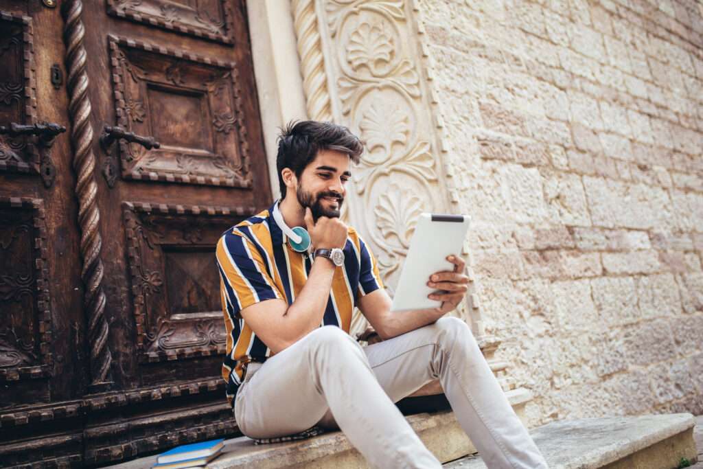 Young handsome tourist men using digital tablet in a city in Jordan