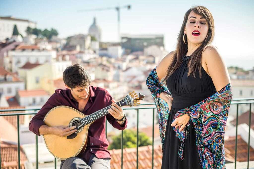 Fado singer performing with a Portuguese guitarist, Portugal.
