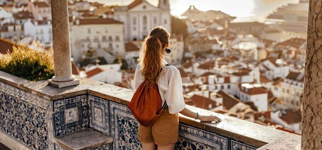 Person looking at breathtaking view of the city in Europe during the sunset 