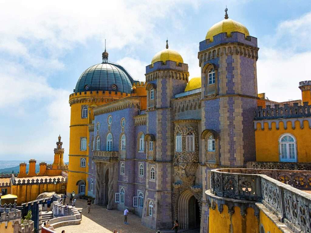 Side view of the colorful façade of Palácio da Pena in Sintra, Portugal.