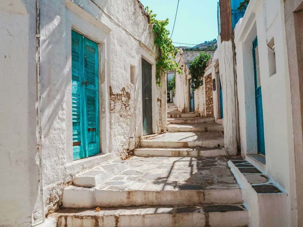 Characteristic street with white greek houses in naxos, greece
