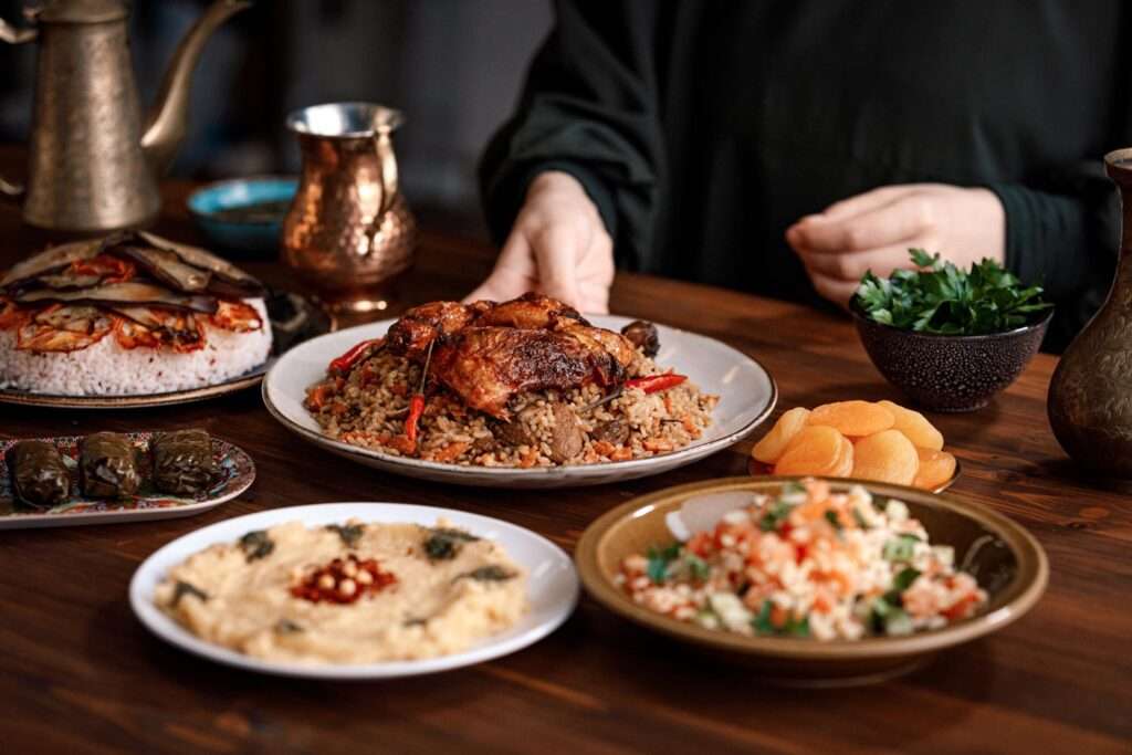 Kabsa, hummus, maqluba, tabbouleh close-up, rice and meat dish, Middle Eastern traditional food.